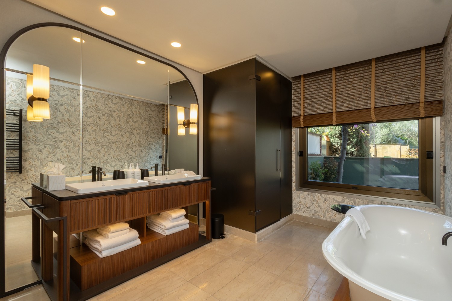 Contemporary bathroom design featuring large windows that integrate natural light and the landscape into the wellness space.